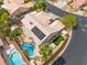 Aerial view of a tan home featuring a tile roof, pool, and solar panels at 7401 Bridlehorne Ave, Las Vegas, NV 89131
