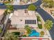 Aerial view of a tan home featuring a tile roof, pool, and solar panels at 7401 Bridlehorne Ave, Las Vegas, NV 89131