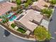 Aerial view of a tan home featuring a tile roof, pool, and small lawn area at 7401 Bridlehorne Ave, Las Vegas, NV 89131