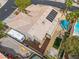 Aerial view of a tan home featuring a tile roof, pool, and solar panels at 7401 Bridlehorne Ave, Las Vegas, NV 89131