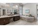 Beautiful bathroom with dual sinks, a soaking tub, and decorative tile accents at 7401 Bridlehorne Ave, Las Vegas, NV 89131