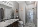 Bright bathroom featuring a glass shower, stylish vanity, and modern fixtures at 7401 Bridlehorne Ave, Las Vegas, NV 89131