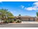Beautiful single-story home boasts a three-car garage, desert landscaping, and a charming front entryway at 7401 Bridlehorne Ave, Las Vegas, NV 89131