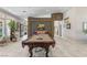 Spacious game room with a pool table, comfortable seating, and a view of the backyard through large windows at 7401 Bridlehorne Ave, Las Vegas, NV 89131