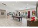 Spacious game room featuring a pool table, recessed lighting, tile floors and large windows overlooking the backyard at 7401 Bridlehorne Ave, Las Vegas, NV 89131