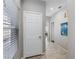 Hallway leading to other rooms in the house, featuring neutral paint and tile flooring at 7401 Bridlehorne Ave, Las Vegas, NV 89131