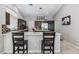 Modern kitchen with granite countertops, island with seating, and stainless appliances at 7401 Bridlehorne Ave, Las Vegas, NV 89131