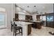 Modern kitchen with dark wood cabinets, stainless steel appliances, a center island and recessed lighting at 7401 Bridlehorne Ave, Las Vegas, NV 89131