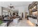 Spacious living room featuring a stone fireplace, tile floors, and an open floor plan to the kitchen and dining area at 7401 Bridlehorne Ave, Las Vegas, NV 89131