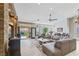 Bright and open living room with a stone accent wall, tile floors and large windows to the backyard at 7401 Bridlehorne Ave, Las Vegas, NV 89131