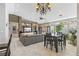 Open concept living room with gray color palette, stone accent wall, and backyard access at 7401 Bridlehorne Ave, Las Vegas, NV 89131