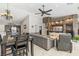 Open concept living room and kitchen featuring dark wood cabinets, tile floors and stone accent wall at 7401 Bridlehorne Ave, Las Vegas, NV 89131
