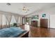 Large main bedroom with hardwood floors and natural light from wide windows at 7401 Bridlehorne Ave, Las Vegas, NV 89131