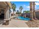 Beautiful backyard pool with rock waterfall and palm trees at 7401 Bridlehorne Ave, Las Vegas, NV 89131