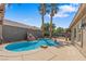 Backyard swimming pool with rock waterfall feature and ample patio space at 7401 Bridlehorne Ave, Las Vegas, NV 89131