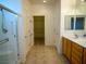Bright bathroom featuring vanity and enclosed shower with handicap bar at 7668 Broadwing Dr, North Las Vegas, NV 89084
