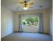 Neutral carpeted bedroom with ceiling fan and large window for natural lighting at 7668 Broadwing Dr, North Las Vegas, NV 89084