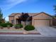 Charming single-story home with a two-car garage and desert landscaping at 7668 Broadwing Dr, North Las Vegas, NV 89084