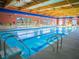 A community indoor pool with lane markers, multiple entry points, and ample lighting at 7668 Broadwing Dr, North Las Vegas, NV 89084