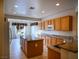 Bright, open kitchen with granite countertops, tile flooring, and a central island at 7668 Broadwing Dr, North Las Vegas, NV 89084