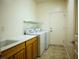 Bright laundry room features a washer, dryer, storage, and sink for convenience at 7668 Broadwing Dr, North Las Vegas, NV 89084