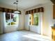 Bright living room featuring large windows with sunlight and neutral tile flooring at 7668 Broadwing Dr, North Las Vegas, NV 89084