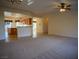 Bright living room with views of the kitchen and breakfast bar seating at 7668 Broadwing Dr, North Las Vegas, NV 89084
