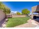 Green backyard with artificial turf and a play area, perfect for entertaining and relaxation at 776 Flowing Meadow Dr, Henderson, NV 89014