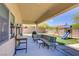 Outdoor patio with seating area, backyard with artificial turf and playset, perfect for families at 776 Flowing Meadow Dr, Henderson, NV 89014