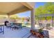 A well-appointed backyard patio features plush seating, a dining area, and a view of the playground at 776 Flowing Meadow Dr, Henderson, NV 89014