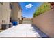 Wide backyard with a long concrete slab next to a block wall, plus desert landscaping and access gate at 776 Flowing Meadow Dr, Henderson, NV 89014