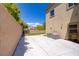 Spacious backyard with a large concrete patio, block wall, and vibrant plants for privacy at 776 Flowing Meadow Dr, Henderson, NV 89014