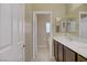 Well-lit bathroom featuring a double sink vanity with dark wood cabinets and tile flooring at 776 Flowing Meadow Dr, Henderson, NV 89014