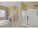 This bathroom boasts a soaking tub, glass shower, and a double sink vanity at 776 Flowing Meadow Dr, Henderson, NV 89014