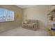 Bedroom with a comfortable love seat near window with white blinds and adjacent shelving at 776 Flowing Meadow Dr, Henderson, NV 89014