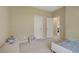 Cozy, carpeted bedroom with neutral walls, complemented by a small chair and a neatly made bed at 776 Flowing Meadow Dr, Henderson, NV 89014