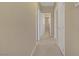 Neutral-toned hallway featuring multiple doorways and carpeted flooring providing access to various rooms at 776 Flowing Meadow Dr, Henderson, NV 89014