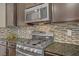Close up of kitchen featuring stainless steel appliances and decorative tile backsplash at 776 Flowing Meadow Dr, Henderson, NV 89014