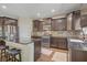 Modern kitchen featuring stainless steel appliances, dark wood cabinets, granite counters, and eat in bar seating at 776 Flowing Meadow Dr, Henderson, NV 89014