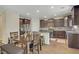 Modern kitchen with stainless steel appliances, granite countertops, and a dining area at 776 Flowing Meadow Dr, Henderson, NV 89014