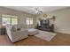 Bright living room with comfortable seating, large windows, and an entertainment center at 776 Flowing Meadow Dr, Henderson, NV 89014