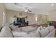 Cozy living room with neutral tones, a staircase, and a view into other rooms at 776 Flowing Meadow Dr, Henderson, NV 89014