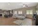 Open-concept living room featuring a large sectional sofa and adjacent kitchen area at 776 Flowing Meadow Dr, Henderson, NV 89014