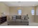 Inviting upstairs living room with comfortable couch, decorative pillows, and neutral carpet at 776 Flowing Meadow Dr, Henderson, NV 89014