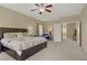 Comfortable carpeted main bedroom featuring neutral walls and a doorway to an en-suite bathroom at 776 Flowing Meadow Dr, Henderson, NV 89014