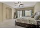 Large main bedroom showcasing plush carpet, private balcony, and stylish ceiling fan at 776 Flowing Meadow Dr, Henderson, NV 89014