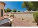 View of backyard area with minimal desert landscaping and block wall fence at 8028 Hurricane Cove Ct, Las Vegas, NV 89129