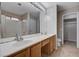 Bright bathroom featuring a double sink vanity and shower with white tile surround at 8028 Hurricane Cove Ct, Las Vegas, NV 89129