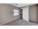 Cozy bedroom featuring neutral walls, carpet, a window, and a sliding door closet at 8028 Hurricane Cove Ct, Las Vegas, NV 89129