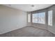 Bedroom with carpet and neutral walls featuring several windows for ample light at 8028 Hurricane Cove Ct, Las Vegas, NV 89129